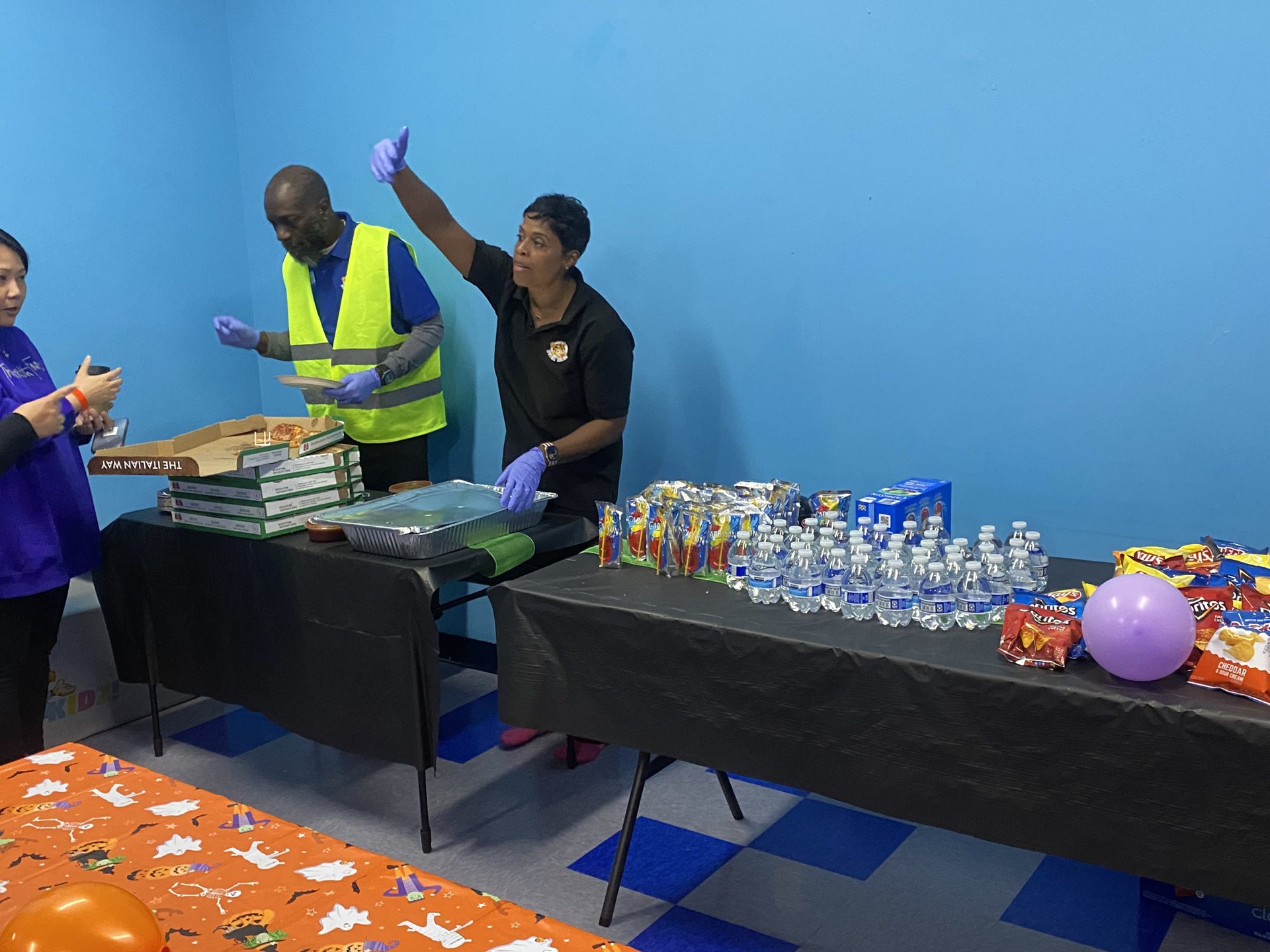 Hyper Kidz Crofton staff serving pizza, snacks and drinks in a party room for a large kids birthday party